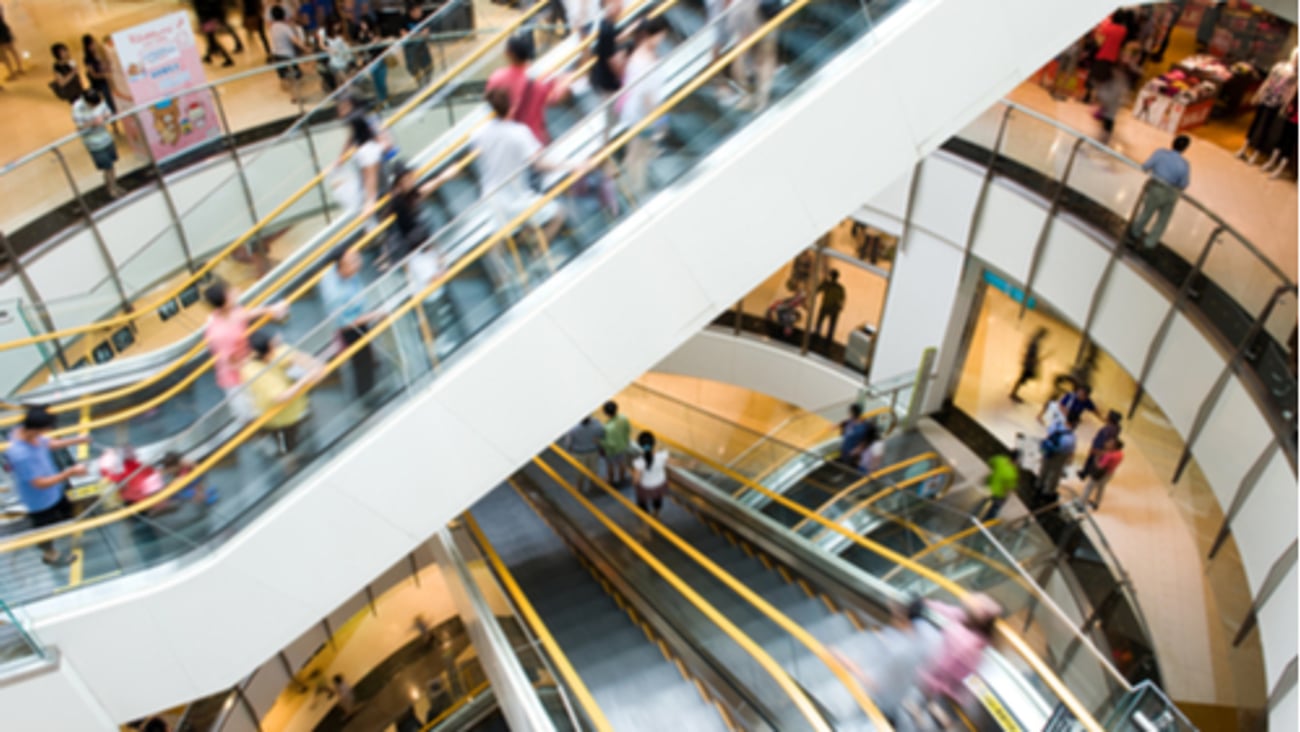 People in motion in escalators at the modern shopping mall.