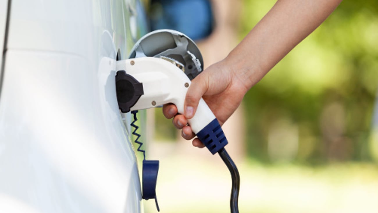 Electric car battery charging at charge station in the nature