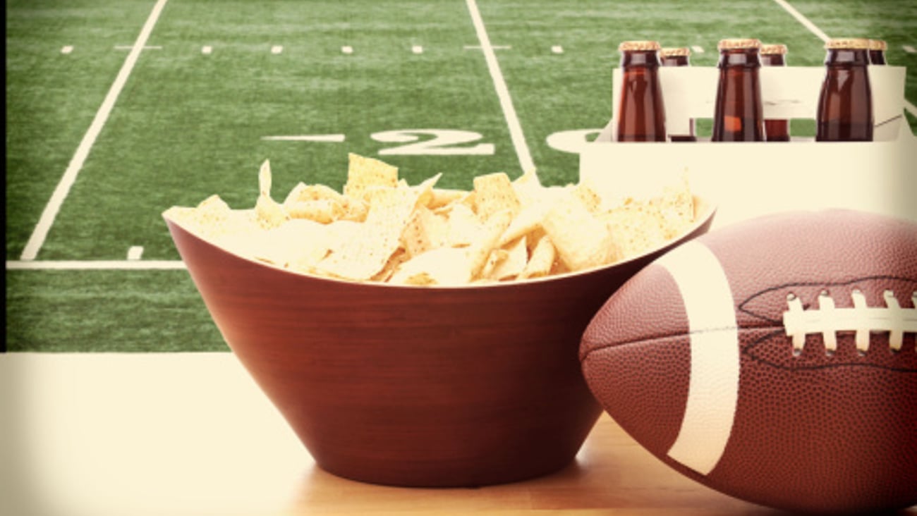 Super Bowl football with a bowl of chips and beer
