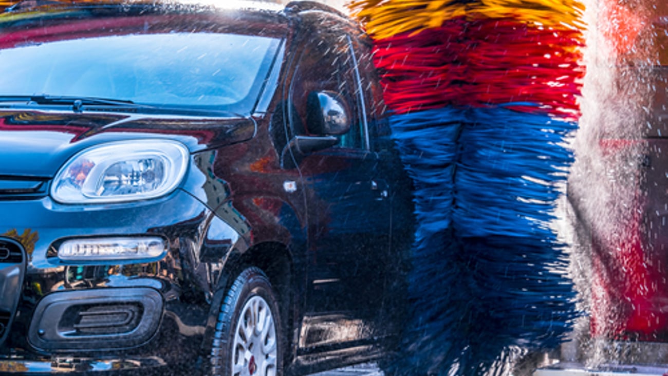 Car going through an automated car wash machine.