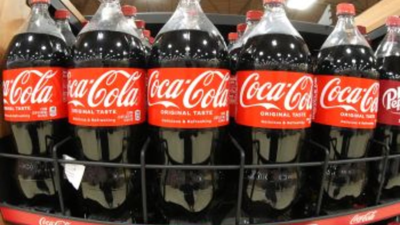 Coke bottles on a shelf AP Photo Teaser