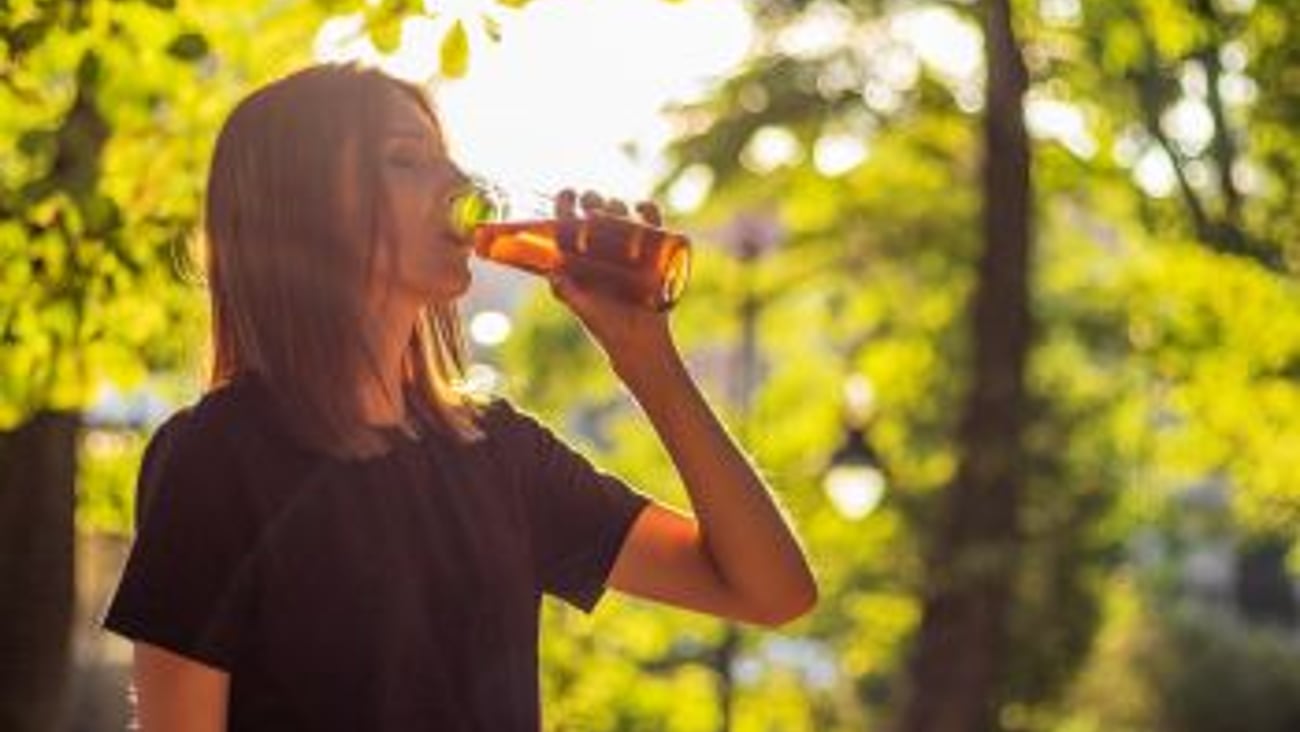 Woman drinking iced tea teaser stock image