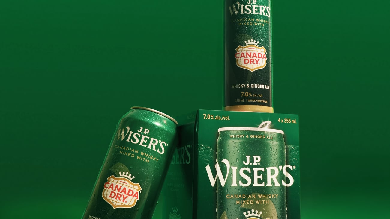 image of product, can leaning on product box and one on top, everything very green like Canada Dry.