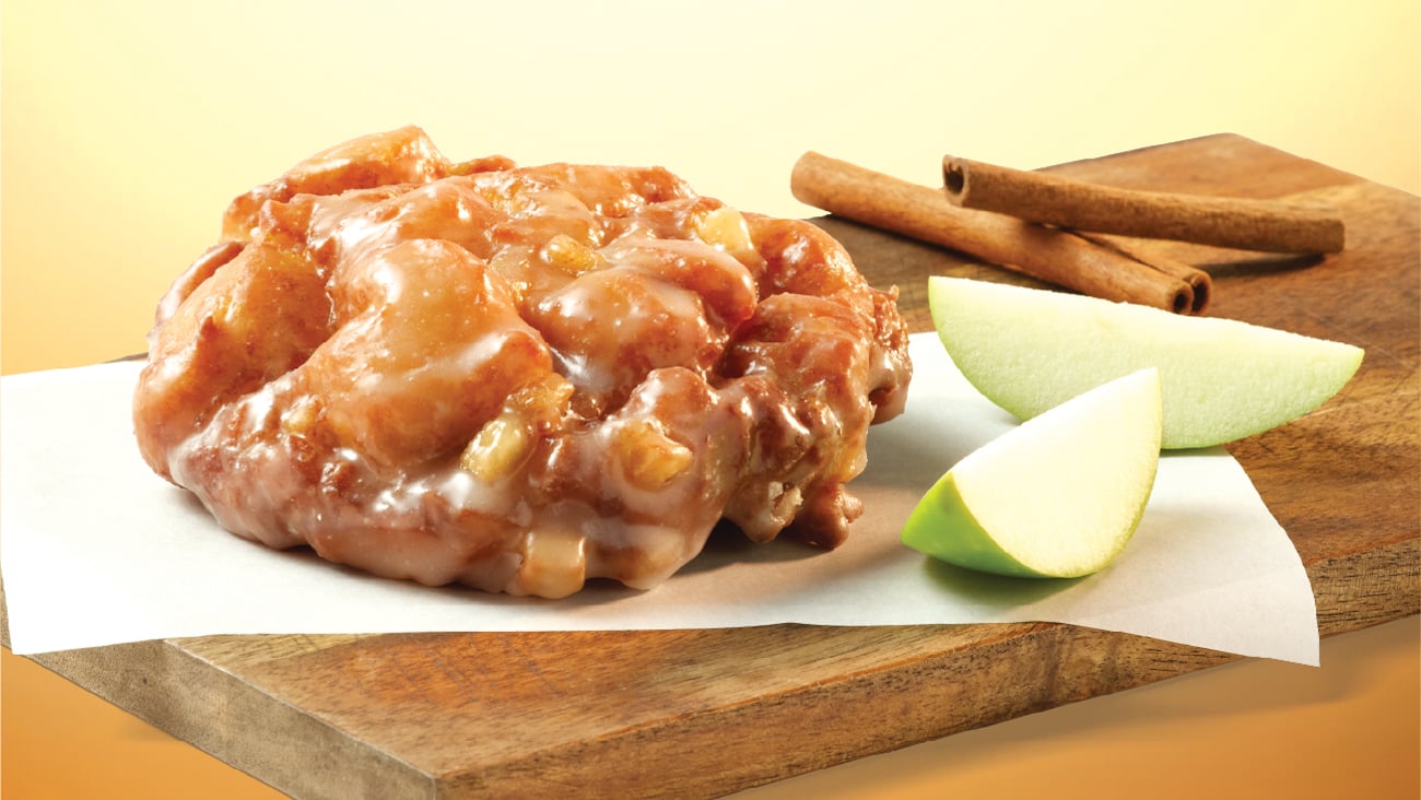 appple fritter pastry alongside apple slices and cinnamon