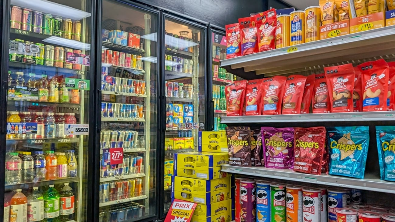 Convenience store offering energy drinks, alcoholic beverages and salty snacks on the shelves.