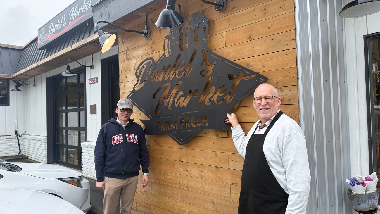 Daniel Tsai and Evan Milner in front of the store