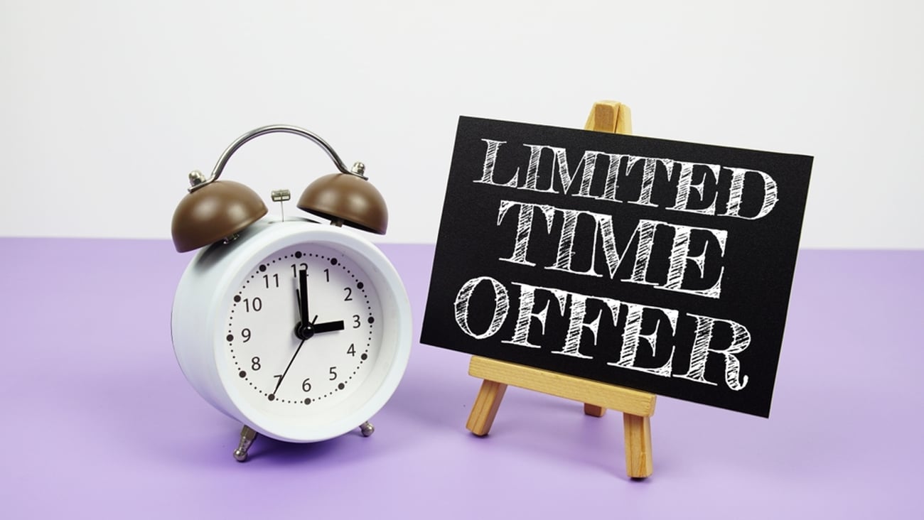 alarm clock next to a chalkboard sign that reads, "limited time offer"
