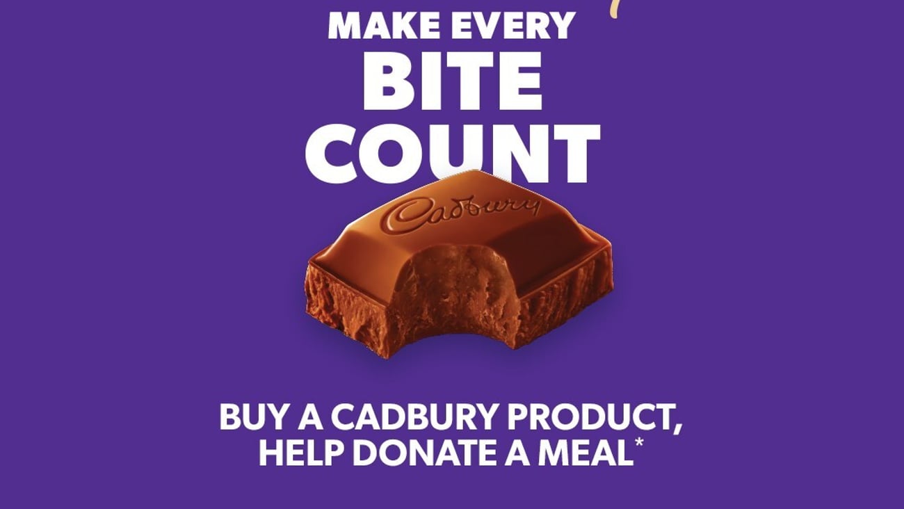 Mondelez international logo for Cadbury, featuring a square of chocolate with a bite take out of it and the charity's logo: Make Every Bite Count.