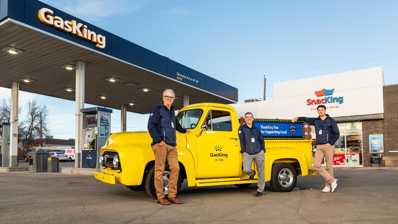 Brent Morris, left, in front of a bright yellow truck in Gas King's forecourt