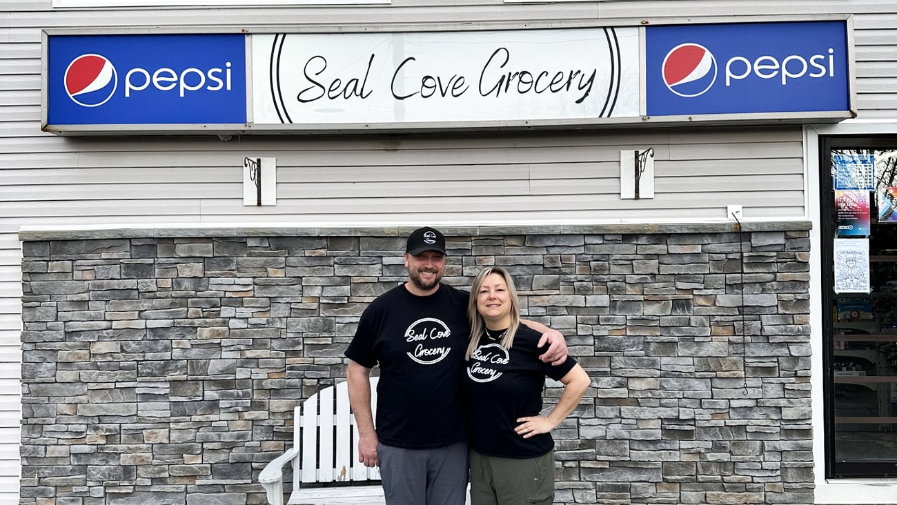 Owners of Seal Cove Grocery & Liquor Express, Kristen and Thomas Dwyer stand in front of their store