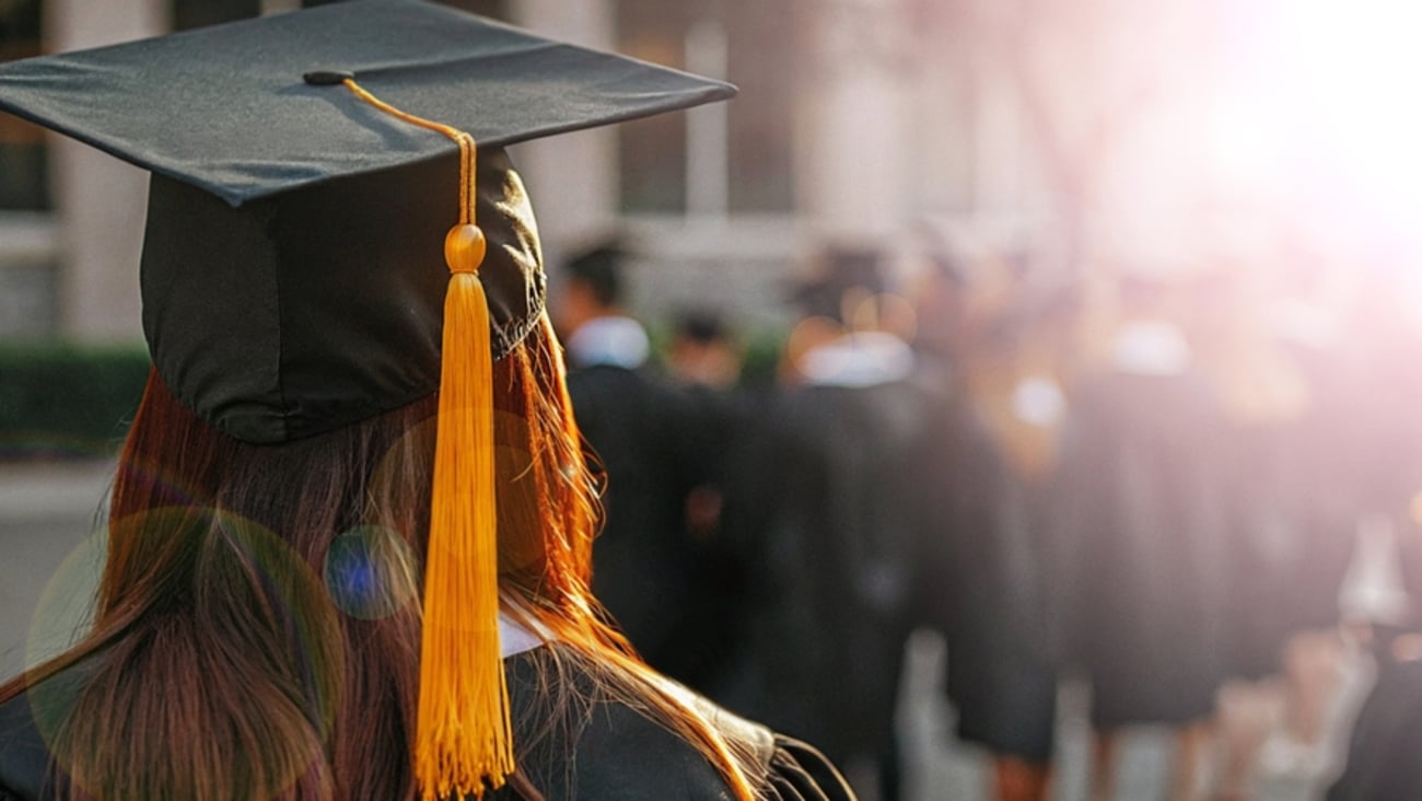 back of a student's head in a graduation procession