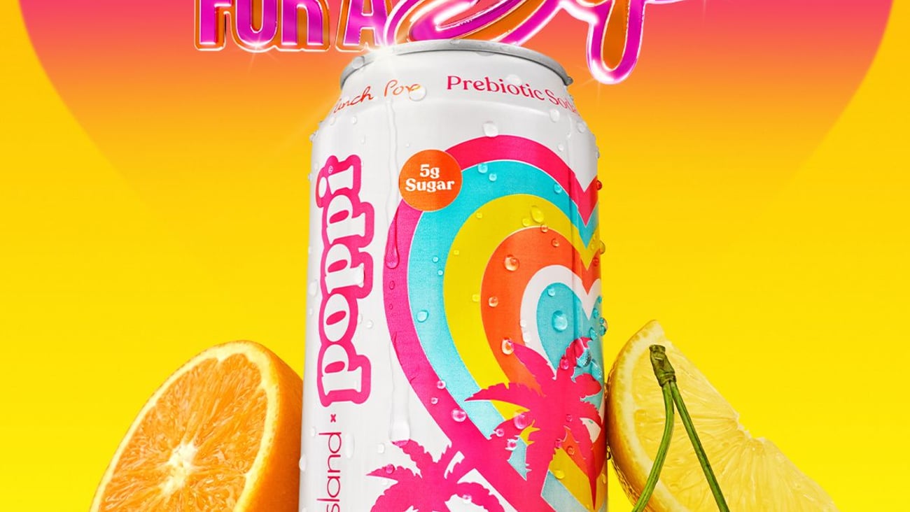 Love Island themed Poppi Punch can next to an orange slice and a pair of cherries