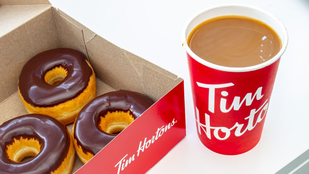 box of chocolate glazed Tim Hortons doughnuts with Tim Hortons coffee