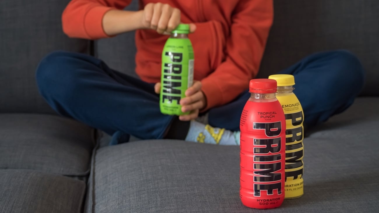 Child opening bottle of Prime energy drink