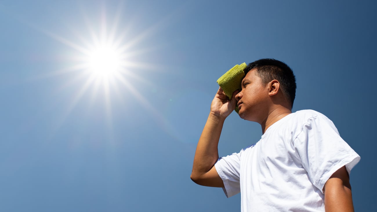 Man standing under hot sun