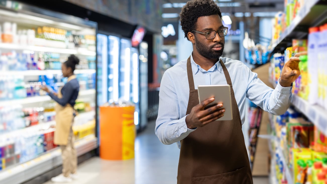 clerk and customer in grocery aisle