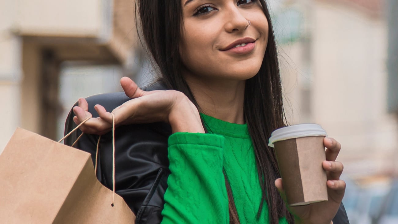 woman with shopping bags and coffee