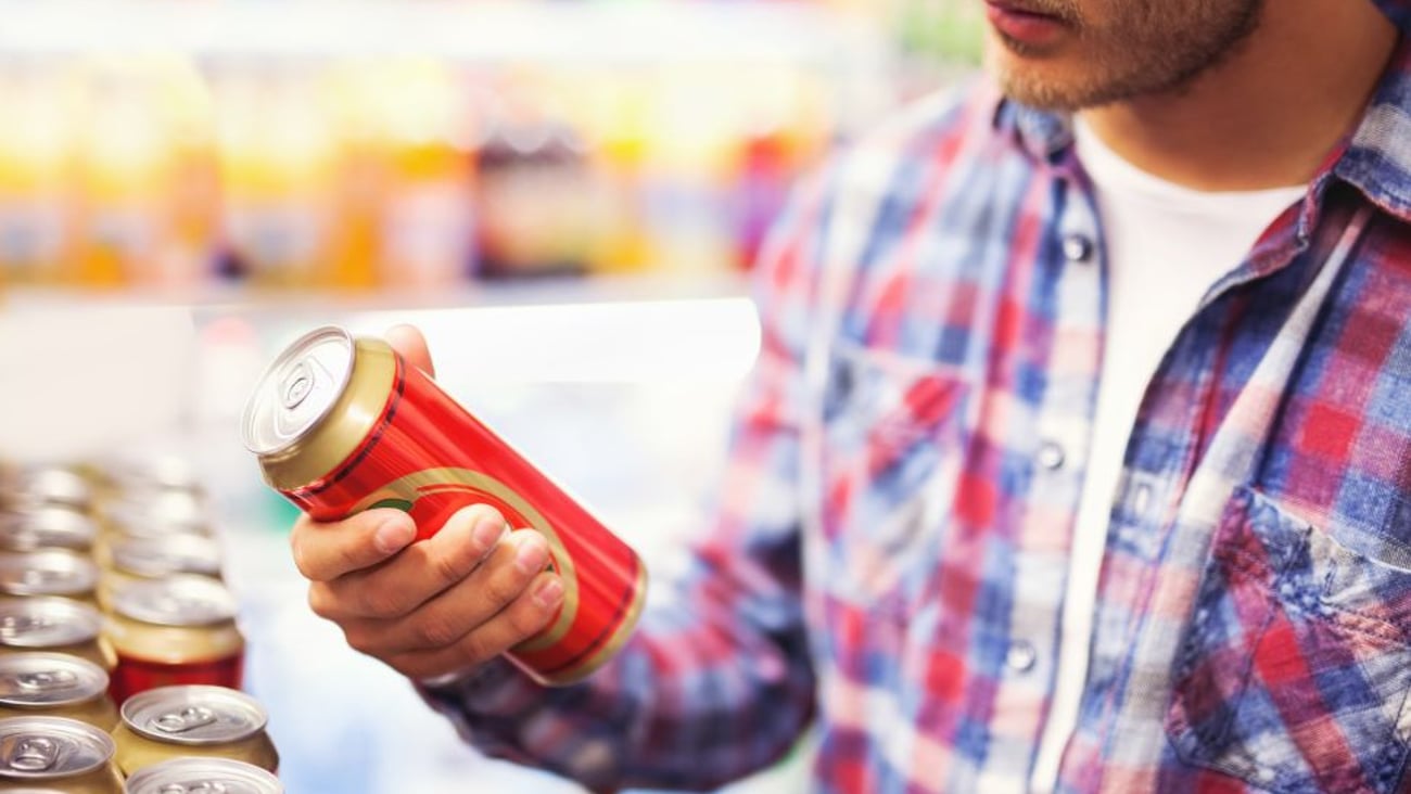 Stock photo of man holding beer can