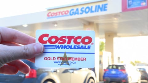 costco membership car held up in front of gas station