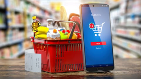 Shopping basket with fresh food and smartphone. Grocery supermarket, food and eats online buying and delivery concept. 