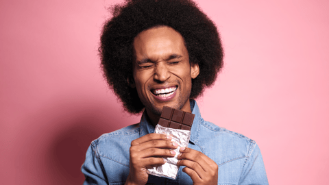 happy man eating chocolate