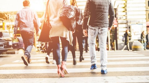 Crowd of people walking on zebra crossing street city center - Concept of modern, rushing, urban, city life, business, shopping - Focus on woman black bag