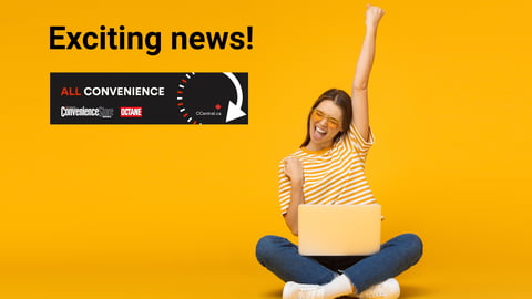 Woman cheering as she looks at something on her laptop