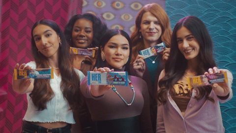 Five young women from Hershey Canada's HerShe campaign hold up chocolate bars.