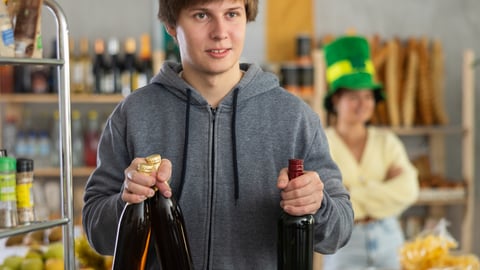 young man buying bottles of wine