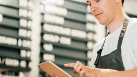 store staff using a POS systems on a tablet