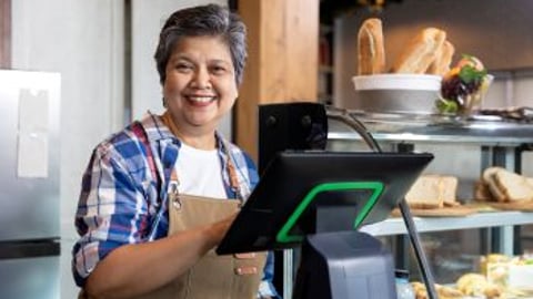 Older Store Owner Behind Counter Stock Image Teaser