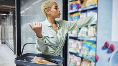 Shopper at a store fridge stock image