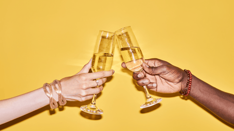 Cheers, sparkling wine, two hands in toast
