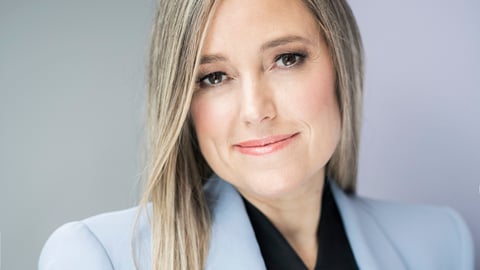 Amber Mac in a blue suit jacket