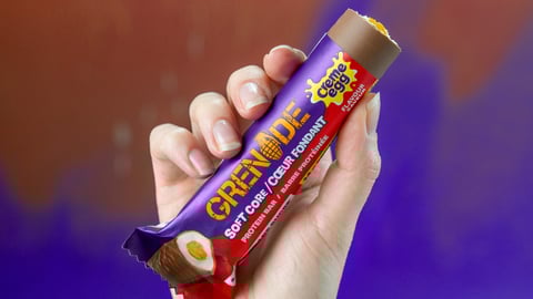 Grenade Cream-Egg inspired bar being held in the air