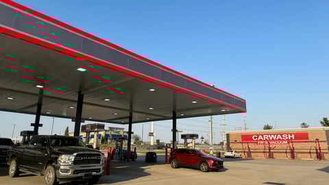 gas station with car wash in the background