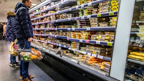 white male looking at food shelves in store