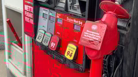 close up red gas pump showing fuel grades