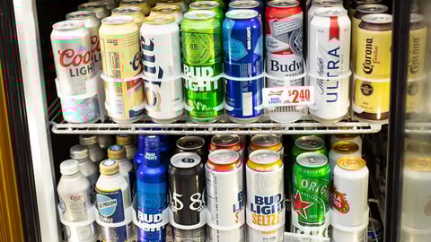 American beers seen behind glass in a convenience store fridge