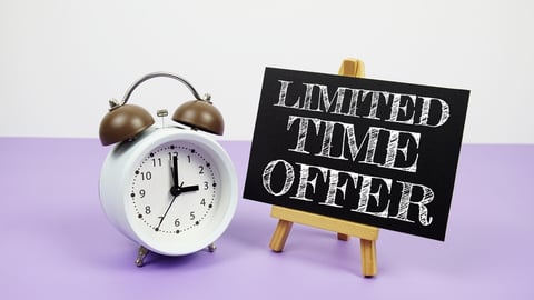 alarm clock next to a chalkboard sign that reads, "limited time offer"