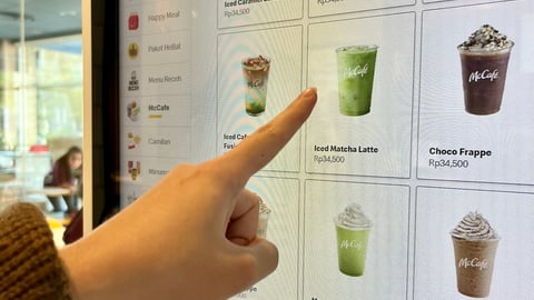hand selecting a drink from McDonald's electronic drinks menu