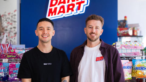 Kevin Wong (left) and Mike Smaill (right) in front of their counter with Dank Mart sign behind them.