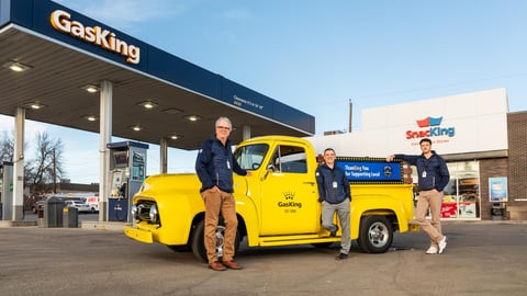 Brent Morris, left, in front of a bright yellow truck in Gas King's forecourt