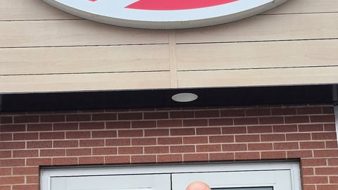 Unnamed owner stands in front of Mel's convenience store.