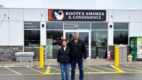 Owners: Brenda and Randy Roote in front of their gas pumps at Roote's Gas Barote"s