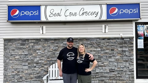 Owners of Seal Cove Grocery & Liquor Express, Kristen and Thomas Dwyer stand in front of their store