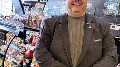 Operator Éric Labranche in front of his counter at Dépanneur Voisin Famille Baril