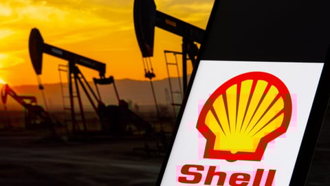 Shell logo in front of a background of oil wells