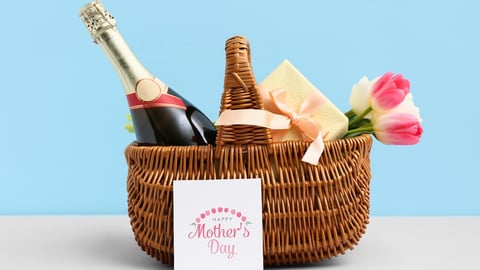 A gift basket of wine, flowers and a mother's day card