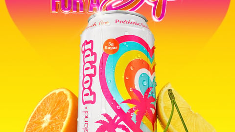 Love Island themed Poppi Punch can next to an orange slice and a pair of cherries